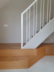 Plateforme sous un escalier avec meuble TV, réalisée à Garches, Vaucresson et Saint-Cloud par Olga Chihai Dusciac.